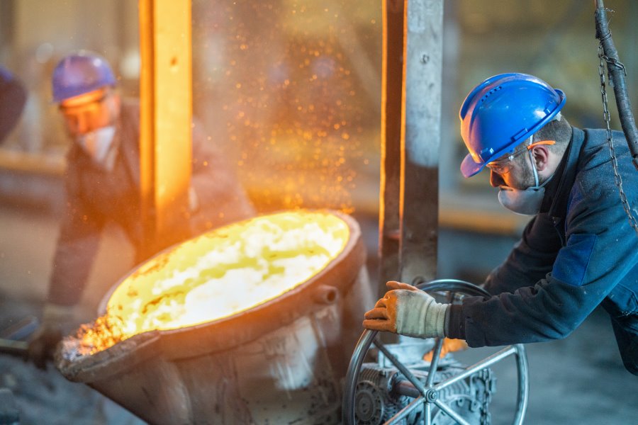 Worker pouring red hot molten steel