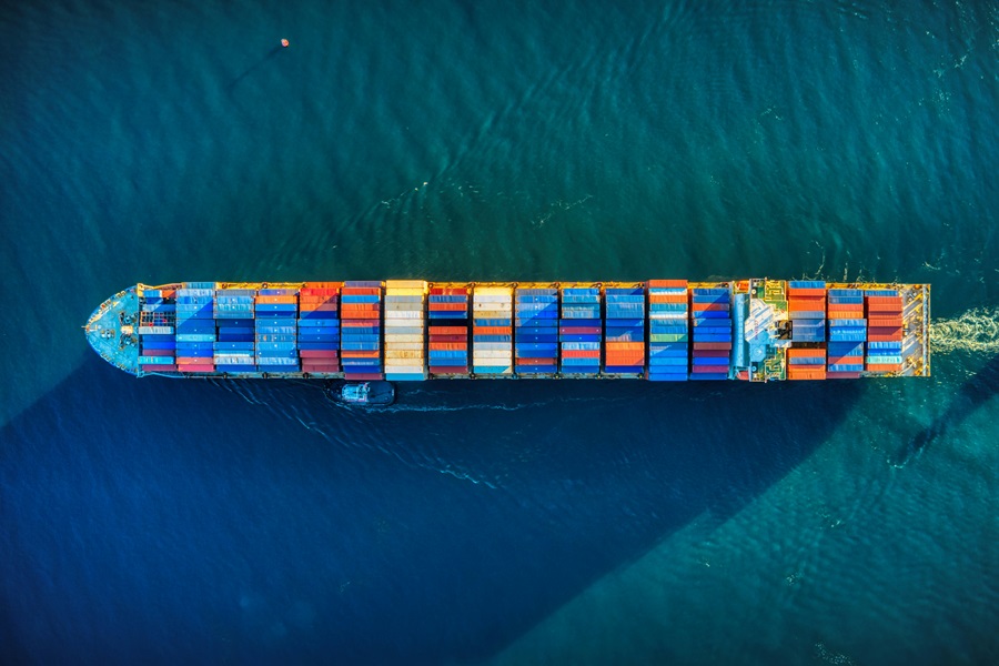 large container ship with colorful containers at sea