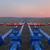 Blue pipes, red valves, sunset